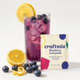 Bourbon Blueberry Lemonade mix with prepared drink, fresh blueberries and lemon