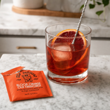 Finished blood orange old fashioned cocktail with orange twist