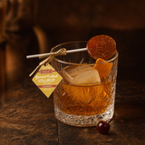 Old Fashioned bourbon lollipop resting on a rocks glass