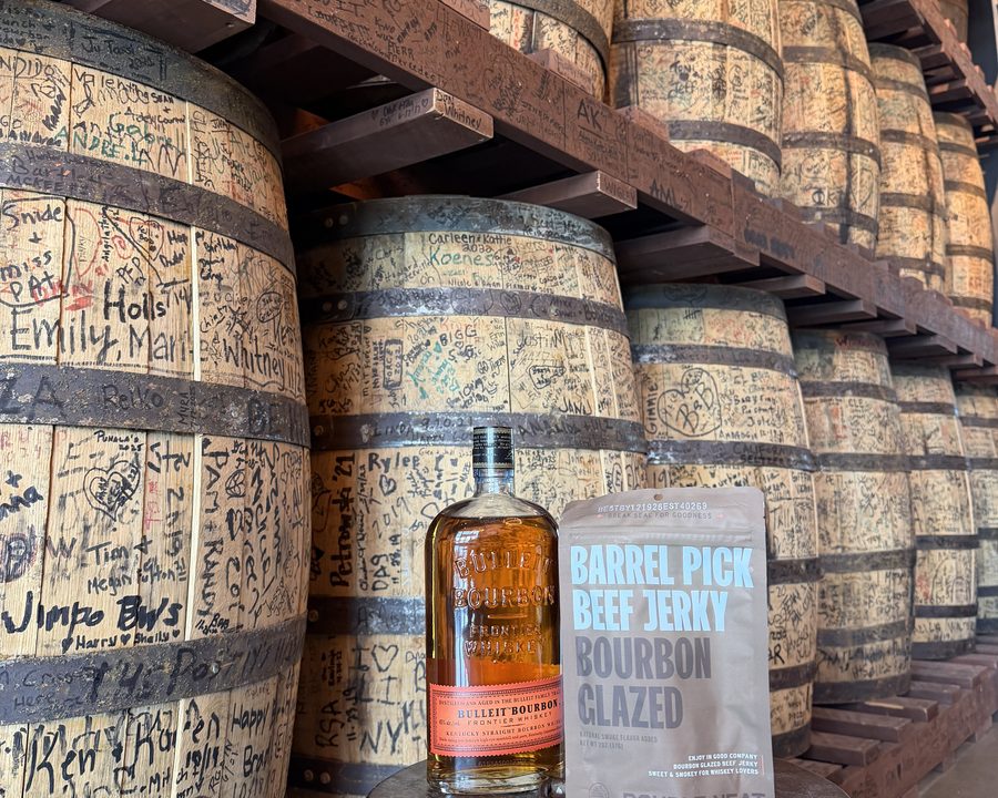 Double Neat jerky with a bottle of Bulleit in the Bulleit barrel room