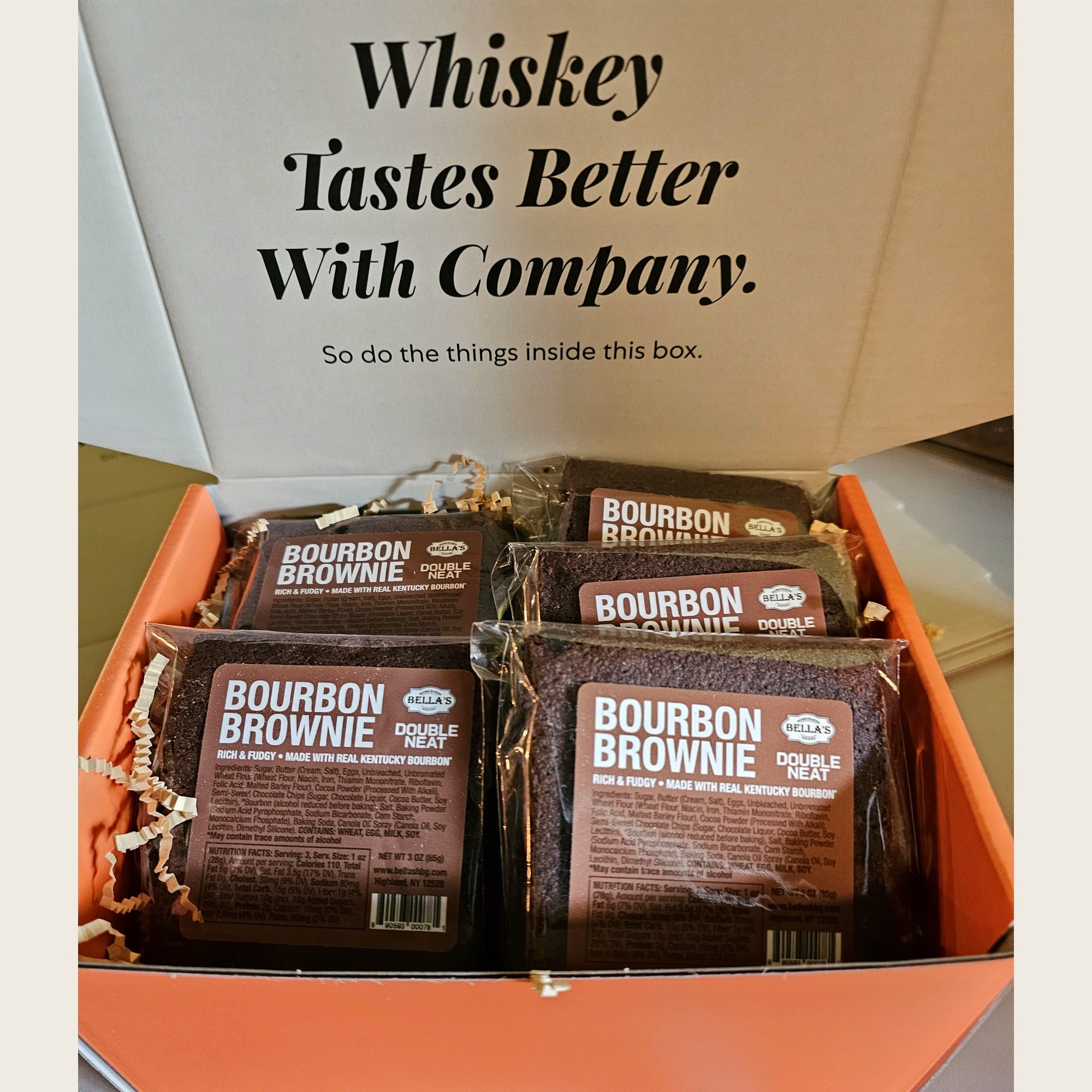 Open orange Double Neat gift box packed with twelve individually wrapped Bourbon Brownies