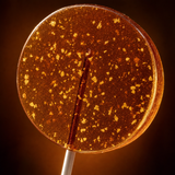Close-up of Old Fashioned bourbon lollipop with embedded lemon zest